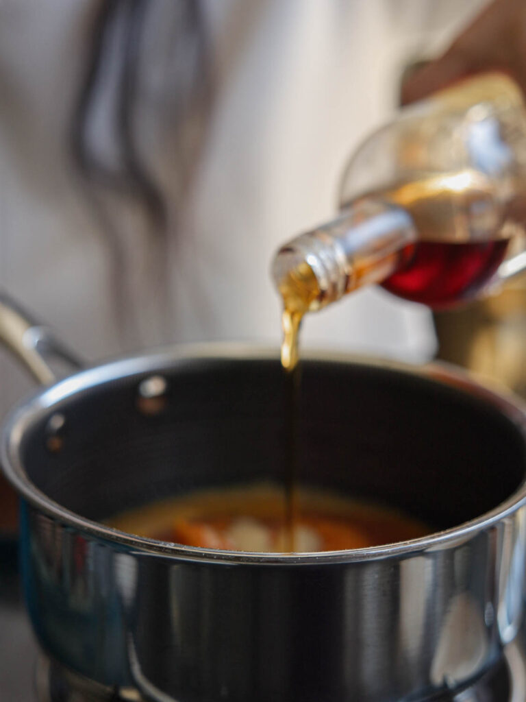 adding maple syrup to pot